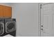 Functional laundry room with modern washer and dryer and access to the backyard at 5009 Kingsley Manor Ct, Marietta, GA 30066