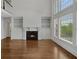 Bright living room with a fireplace, built-in shelving, and many large windows at 5009 Kingsley Manor Ct, Marietta, GA 30066