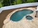 An in-ground pool and hot tub surrounded by a stamped concrete patio and new landscaping at 5009 Kingsley Manor Ct, Marietta, GA 30066