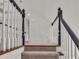 Carpeted stairway with white railing and wood trim at 5009 Kingsley Manor Ct, Marietta, GA 30066