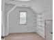 Spacious walk-in closet featuring built-in shelving, rods, and natural light from the window at 5009 Kingsley Manor Ct, Marietta, GA 30066
