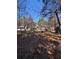 Backyard featuring a small deck, mature trees, and natural surroundings at 2807 Mcclave Dr, Doraville, GA 30340