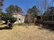 Backyard features mature trees and a mix of grass and mulch at 2807 Mcclave Dr, Doraville, GA 30340