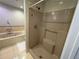 Bathroom featuring a walk-in shower and separate soaking tub with tiled surround at 2807 Mcclave Dr, Doraville, GA 30340