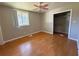 Bedroom with hardwood floors, neutral paint, closet, and modern ceiling fan at 2807 Mcclave Dr, Doraville, GA 30340