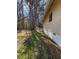 A clean home exterior with well-maintained siding and trim surrounded by mature trees offering shade and privacy at 2807 Mcclave Dr, Doraville, GA 30340
