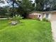 Charming single-story home featuring lush front lawn with lovely flower beds and brick accent wall at 2807 Mcclave Dr, Doraville, GA 30340