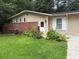 Well-maintained front yard showcasing vibrant flowerbeds and a charming brick privacy wall at 2807 Mcclave Dr, Doraville, GA 30340