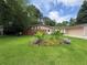 Expansive green front yard featuring a unique flower garden with thriving plants and shrubs at 2807 Mcclave Dr, Doraville, GA 30340