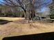 Large front yard with mature trees and a play set near a single-story home at 2807 Mcclave Dr, Doraville, GA 30340