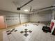 View of a spacious garage with pegboard, shelving, and tile flooring at 2807 Mcclave Dr, Doraville, GA 30340