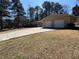 Spacious two car garage adjacent to a long concrete driveway and well-maintained lawn at 2807 Mcclave Dr, Doraville, GA 30340