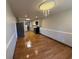 Open kitchen and dining area features wood floors, chandelier, and stainless steel refrigerator at 2807 Mcclave Dr, Doraville, GA 30340