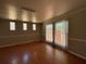 Living room featuring hardwood floors, three large windows, and neutral paint at 2807 Mcclave Dr, Doraville, GA 30340