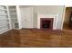 Living room showcasing a decorative fireplace, built-in shelving and hardwood floors at 2807 Mcclave Dr, Doraville, GA 30340