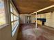 Enclosed sunroom with large windows, wood paneled ceiling, and built in cabinets ready for your updates and finishing touches at 2807 Mcclave Dr, Doraville, GA 30340