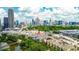 An aerial view showcases the surrounding area and the Atlanta skyline with lake and walking bridge at 400 17Th Street Nw # 2313, Atlanta, GA 30363
