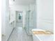 Bright bathroom with double vanity, glass shower, soaking tub, and wood-look tile floors at 400 17Th Street Nw # 2313, Atlanta, GA 30363