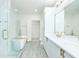 Modern bathroom featuring double vanity, soaking tub, and glass shower with gold hardware at 400 17Th Street Nw # 2313, Atlanta, GA 30363