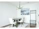 Dining area with wood table, white chairs, modern lighting, and a decorative print at 400 17Th Street Nw # 2313, Atlanta, GA 30363