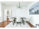 Dining room features a wood table, white chairs, modern lighting, and hardwood floors at 400 17Th Street Nw # 2313, Atlanta, GA 30363