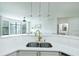 Kitchen features a sink, white counters and cabinets, and views to the living room at 400 17Th Street Nw # 2313, Atlanta, GA 30363