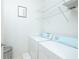 Laundry room with light blue washer and dryer, white shelving, and grey waste bin at 400 17Th Street Nw # 2313, Atlanta, GA 30363