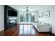 Living room features a fireplace, hardwood floors, and large windows overlooking mature trees at 400 17Th Street Nw # 2313, Atlanta, GA 30363