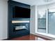 Modern living room featuring dark accent wall with fireplace and large window at 400 17Th Street Nw # 2313, Atlanta, GA 30363