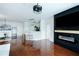 Open floor plan with modern fireplace, breakfast bar, and gleaming hardwood floors at 400 17Th Street Nw # 2313, Atlanta, GA 30363
