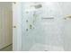Modern shower with marble-look tile and gold fixtures at 400 17Th Street Nw # 2313, Atlanta, GA 30363