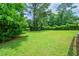 Lush backyard with green grass and mature trees at 4732 Manly Ct, Stone Mountain, GA 30088
