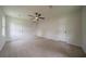 Spacious bedroom featuring carpeted floors, a ceiling fan, and ample closet space at 4732 Manly Ct, Stone Mountain, GA 30088