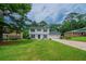 Charming two-story home featuring classic black shutters, lush green lawn and an attached two car garage at 4732 Manly Ct, Stone Mountain, GA 30088
