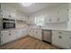 Well-lit kitchen featuring white cabinets, modern countertops, stainless steel appliances, and updated flooring at 4732 Manly Ct, Stone Mountain, GA 30088