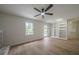 Bright living room with a brick fireplace, modern flooring, access to the exterior, and updated built-in shelving at 4732 Manly Ct, Stone Mountain, GA 30088