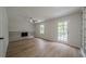 Open-concept living room with a brick fireplace, built-in shelving, contemporary flooring and a ceiling fan at 4732 Manly Ct, Stone Mountain, GA 30088