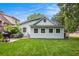 The backyard has a patio, grill, lush green grass, and a charming house at 1292 Eubanks Ave, East Point, GA 30344
