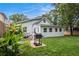 The backyard is complete with a patio and grill, lush green grass, and a charming house at 1292 Eubanks Ave, East Point, GA 30344