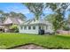 View of the backyard with a patio, grill, lush green grass, and a charming house at 1292 Eubanks Ave, East Point, GA 30344