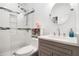 This bathroom has a glassed-in tiled shower and a decorative vanity with round mirror at 1292 Eubanks Ave, East Point, GA 30344