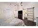 Bedroom featuring a ceiling fan, hardwood floors, and ensuite bathroom access at 1292 Eubanks Ave, East Point, GA 30344