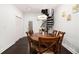 Bright dining room with wooden table, spiral staircase, dark floors and white walls at 1292 Eubanks Ave, East Point, GA 30344
