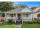 Bungalow-style home with a welcoming front porch, lush landscaping, and a well-manicured lawn at 1292 Eubanks Ave, East Point, GA 30344