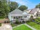 Charming home with a covered front porch, inviting curb appeal and a paved driveway at 1292 Eubanks Ave, East Point, GA 30344
