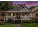Charming bungalow-style home with a welcoming front porch, lush landscaping, and a well-manicured lawn at 1292 Eubanks Ave, East Point, GA 30344
