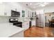 Well-lit kitchen with stainless steel appliances, white cabinets, and a view into the dining room at 1292 Eubanks Ave, East Point, GA 30344