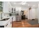 Bright kitchen with stainless steel refrigerator, white cabinets, and hardwood floors at 1292 Eubanks Ave, East Point, GA 30344