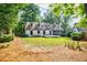 Expansive backyard with a well-maintained lawn, mature trees, and a deck, perfect for outdoor living at 2007 Mount Vernon Pl, Dunwoody, GA 30338