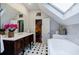 Bathroom with marble tile, tub, skylight, and antique vanity at 2007 Mount Vernon Pl, Dunwoody, GA 30338